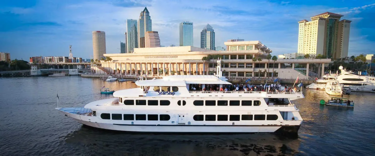 Yacht Starship in bay with Tampa city skyline in background.